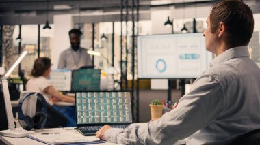 Profesyonel adam, iş istihbaratı, ofiste görsel veriler, analitik gösterge paneli, performans ölçümleri, tahmin raporları, parasal veriler, kaynak tahsisi ve strateji planlamasına yardım etme.