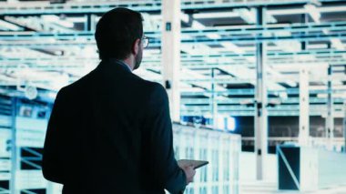 Veri merkezi teknisyeni internet hizmetlerine yardım eden mavi kablo ağ teçhizatını yönetiyor. Dijital depolama sistemleri için yapılmış sunucu çiftliğinin dijital ikiz taramasında yürüyen adam, kamera B