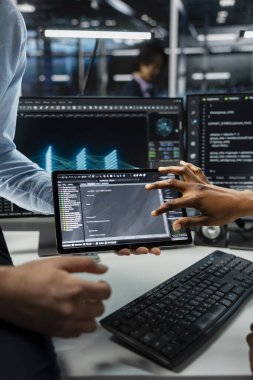 Sunucu çiftliğinde veri madenciliğini destekleyen donanım içeren tablet kullanan sistem yöneticilerini kapat. Bilgi işlem çalışanları veri merkezinde cihaz kullanarak platformların bakımını yapmak için birlikte çalışıyorlar.