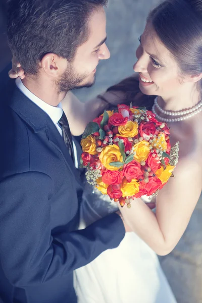 Happy bride and groom smiling to each other — Stock Photo, Image