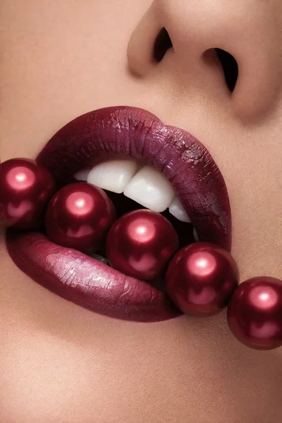 Close up mouth with red pearls and lipstick — Stock Photo, Image