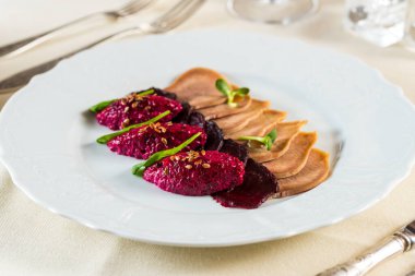 Sığır dili, pancar kökü, tohumlar ve rendelenmiş sığır eti tabağı ile aperatif.