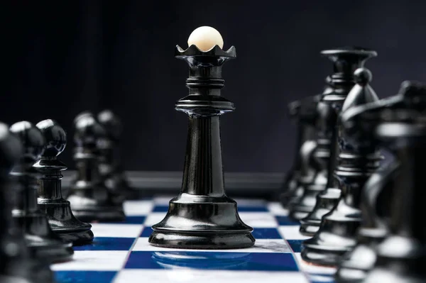 chess king among his black pieces