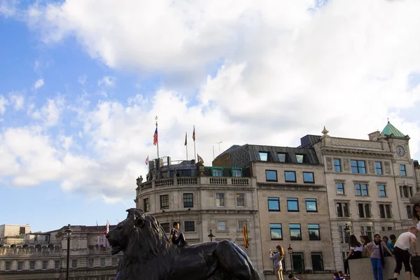 Old building with various flags near Trafalgar Square in London — Stock Photo, Image