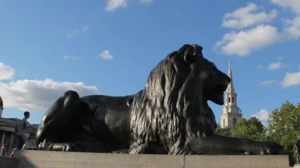 Oidentifierade turister nära skulptur av Barbary lejon på Trafalgar Square — Stockvideo