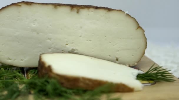 丸みを帯びた柔らかい茶色の自家製スライスチーズ 緑の板の上に横たわっているAdygheチーズ — ストック動画