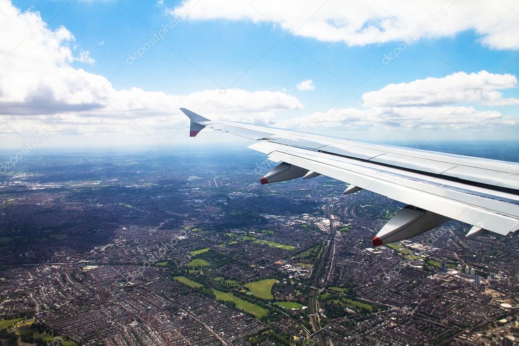 Big airplane  begins to decline and prepares for landing in Heathrow Airport . London. UK