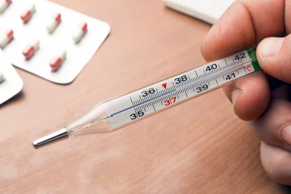 Man Checks His Body Temperature Using Mercury Glass Thermometer — Stock Photo, Image