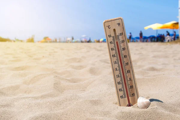 Wooden thermometer buried in the sand of an Italian beach show temperature both in Celsius and Fahrenheit scale