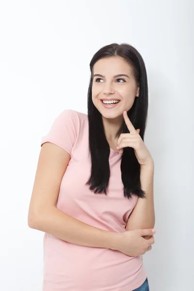 Portrait of an attractive young brunette woman ooking up dreaming. — Stock Photo, Image