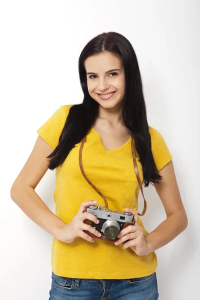 Young Woman Holding retrocamera against white background — Stock Photo, Image