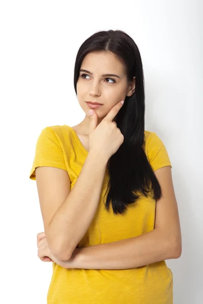 Portrait of an attractive young brunette woman ooking up dreaming. — Stock Photo, Image