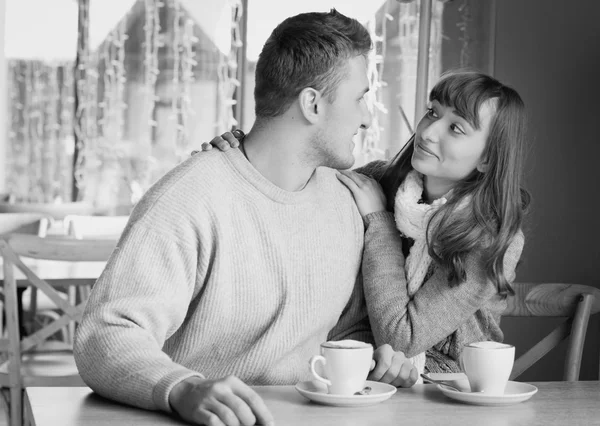 Young people sitting in the cafe and eating dessert. black and white — Stock Photo, Image