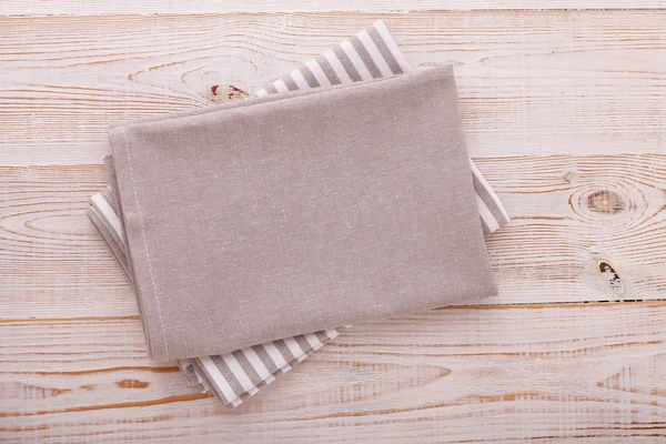 Napkin. Cloth napkin on white wooden background. Top view, mockup.