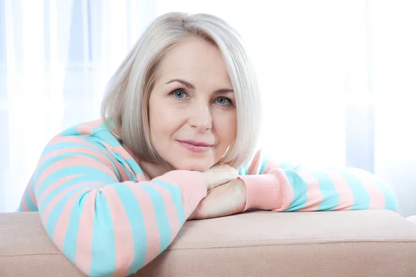 Atractiva mujer de mediana edad mirando en cámara relajante en casa. La hermosa cara de cerca . —  Fotos de Stock