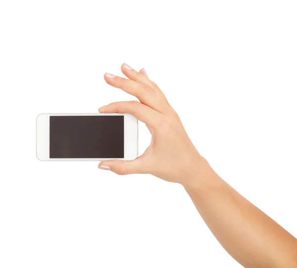 Weibliche Hand zeigt Smartphone mit weißem Bildschirm, Frontansicht, isoliert. — Stockfoto