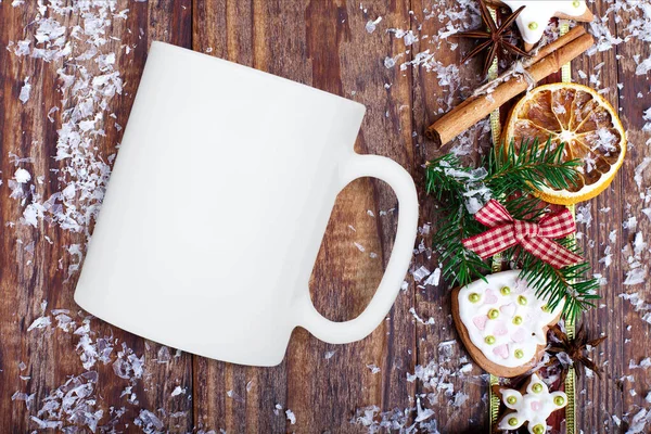 White Mug mockup, blank cup glass with Christmas background. Christmas tree on dark wooden board. Top view.