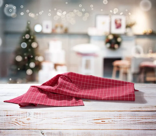 Red napkin on wooden table and Christmas background. — Stock Photo, Image