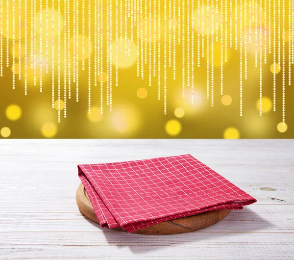 Red napkin on wooden table and Christmas background. — Stock Photo, Image