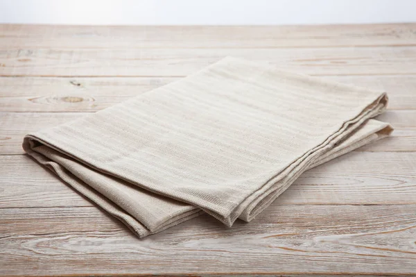 Empty canvas napkin on wooden desk top view — Stock Photo, Image