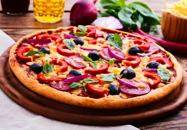 Pizza con prosciutto, pepe e olive. Deliziosa pizza fresca servita sul tavolo di legno . — Foto Stock