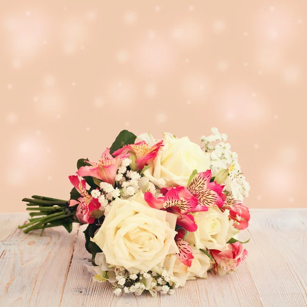 Bridal bouquet of white flowers on wooden surface. — Stock Photo, Image