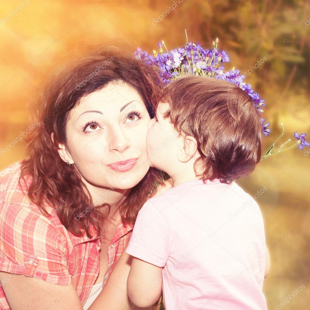 Happy family. Little girl mom gives bouquet of flowers in nature