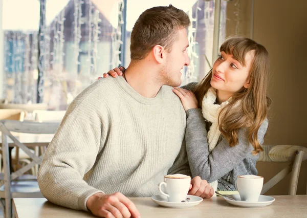 Young people sitting in the cafe and eating dessert. — Stock Photo, Image