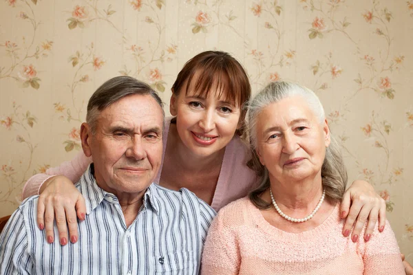 Senior man, woman with their caregiver at home. — Stock Photo, Image