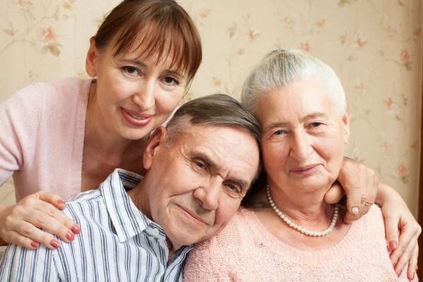 Senior man, woman with their caregiver at home. — Stock Photo, Image