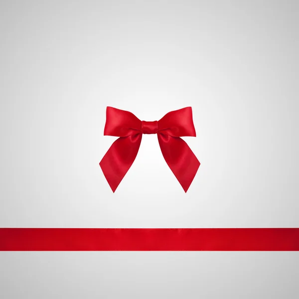 Red ribbon bow on grey background. — Stock Photo, Image