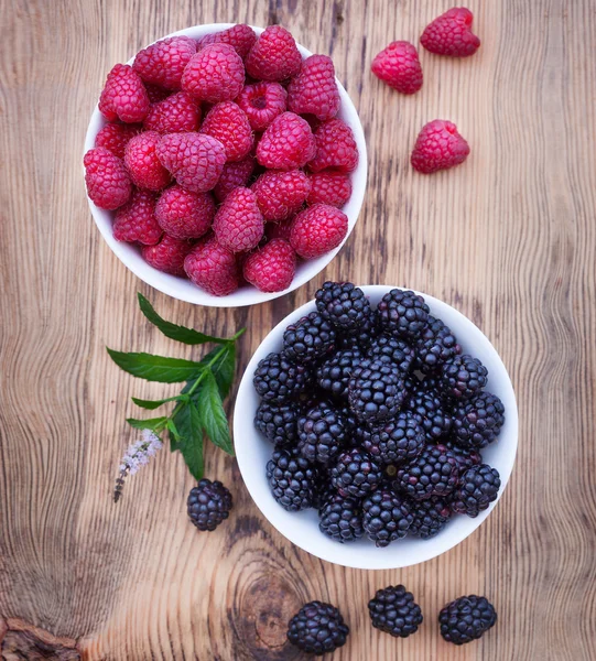 Bowls overflowing with summer berries like raspberries and blackberries. — Stock Image Bowls overflowing with summer berries like raspberries and blackberries. Stock Picture