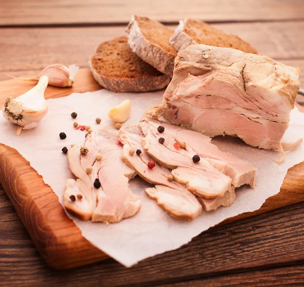 Nice juicy meat with spices on wooden table — Stock Photo, Image