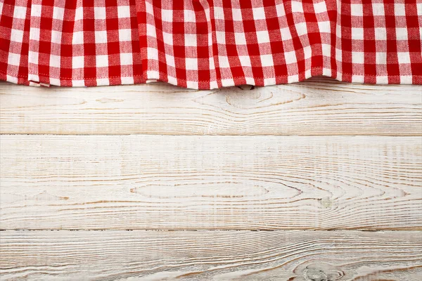 Top view of checkered tablecloth on white wooden table. — Stock Photo, Image