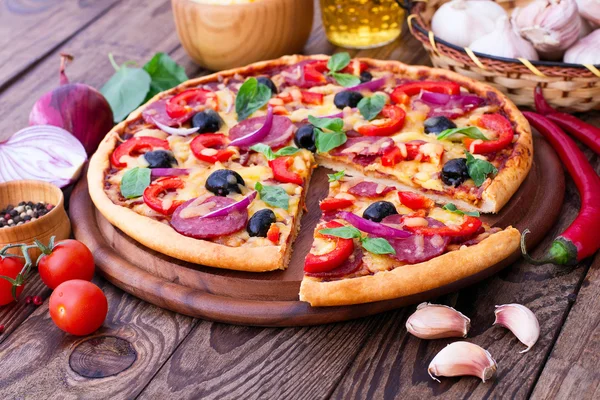 Delicious pizza served on wooden table — Stock Photo, Image