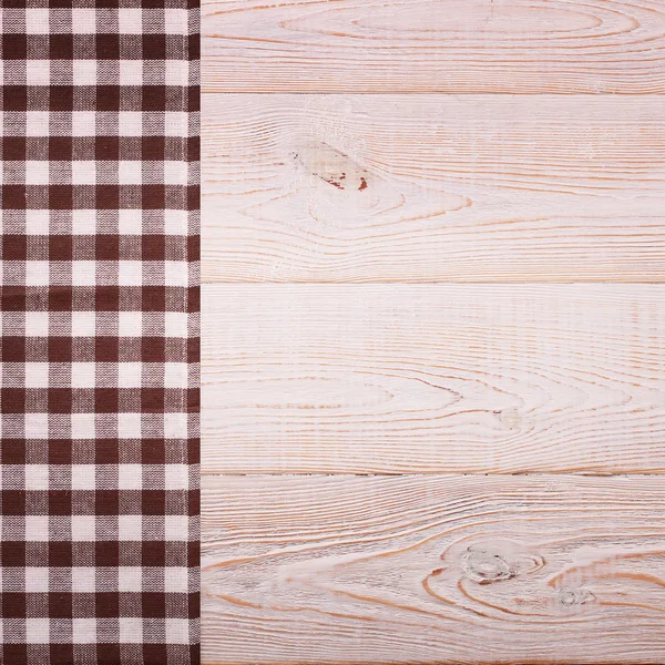 Top view of checkered tablecloth on white wooden table. — Stock Photo, Image
