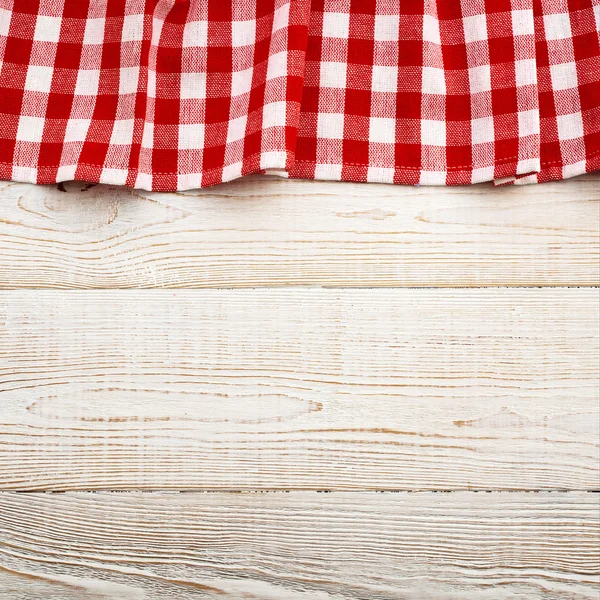 Top view of checkered tablecloth on white wooden table. — Stock Photo, Image