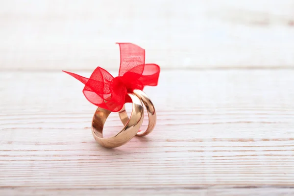 Wedding decoration rings with red ribbon. — Stock Photo, Image