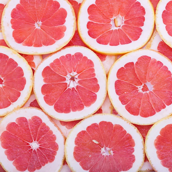 Frutas tropicales cortan círculos como fondo — Foto de Stock