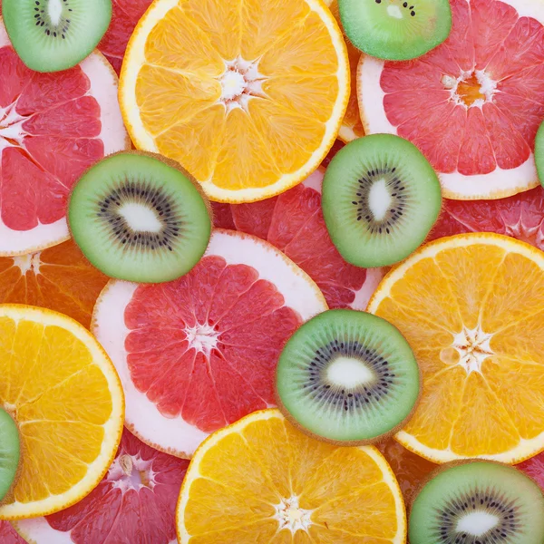 Frutas tropicais cortar círculos como fundo — Fotografia de Stock