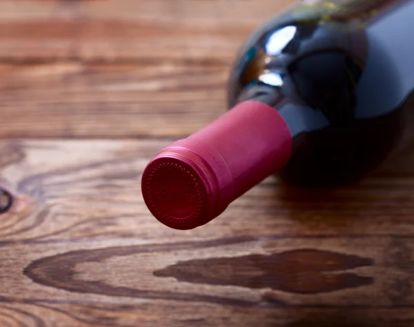 Wine bottles on wooden background — Stock Photo, Image