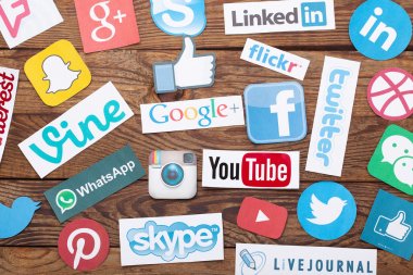 KIEV, UKRAINE - AUGUST 22, 2015:Collection of popular social media logos printed on paper:Facebook, Twitter, Google Plus, Instagram, Pinterest, Skype, YouTube, Linkedin and others  clipart