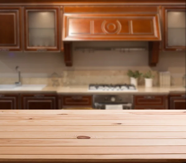 Top of wooden table and kitchen space — Stock Photo, Image