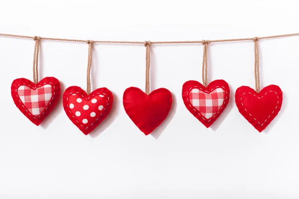 Red hearts hanging on white — Stock Photo, Image