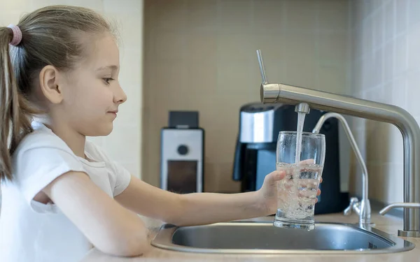 Child open water tap. Kitchen faucet. Glass of clean water. Pouring fresh drink. Hydration. Healthy lifestyle. Water quality check concept. World water monitoring day. Environmental pollution problem