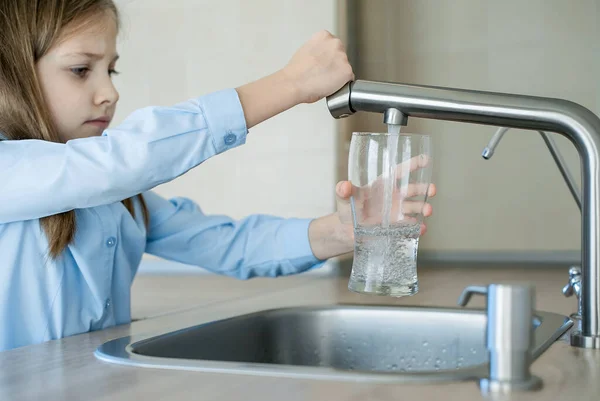 Child open water tap. Kitchen faucet. Glass of clean water. Pouring fresh drink. Hydration. Healthy lifestyle. Water quality check concept. World water monitoring day. Environmental pollution problem