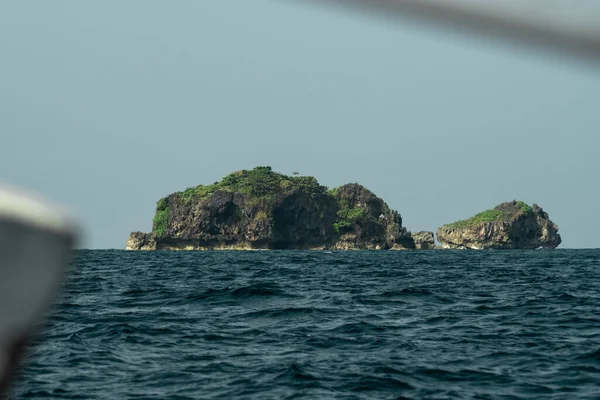 View of two small cliff islets by the Calventuras islands outside Ngwesaung Beach, Irrawaddy, Myanmar from a boat