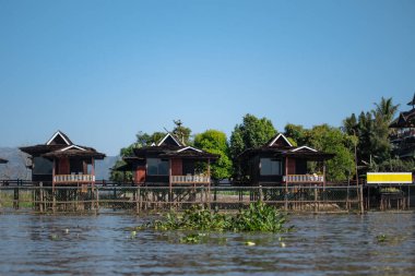 Inle Gölü, Nyaung Shwe, Shan State, Mayanmar 'daki nehir kenarındaki kırmızı binalar.
