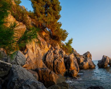 Kayaları ve deniz manzarası olan güzel bir sahil.