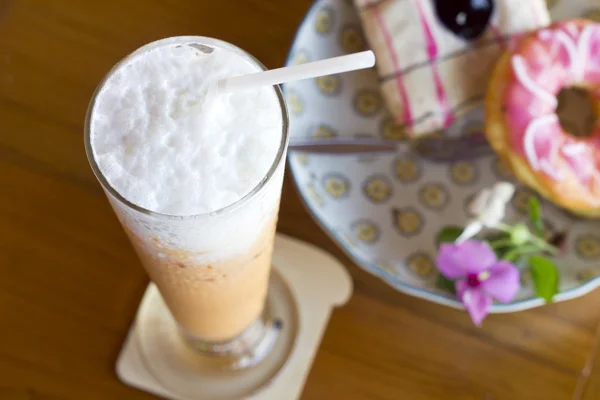 A glass of milk tea and donut — Stock Photo, Image